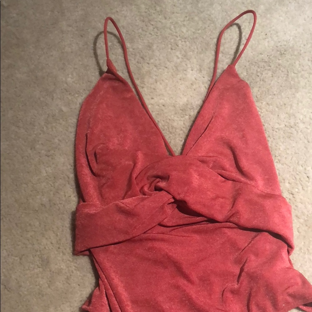 Pink bodysuit with a low cutout in the back